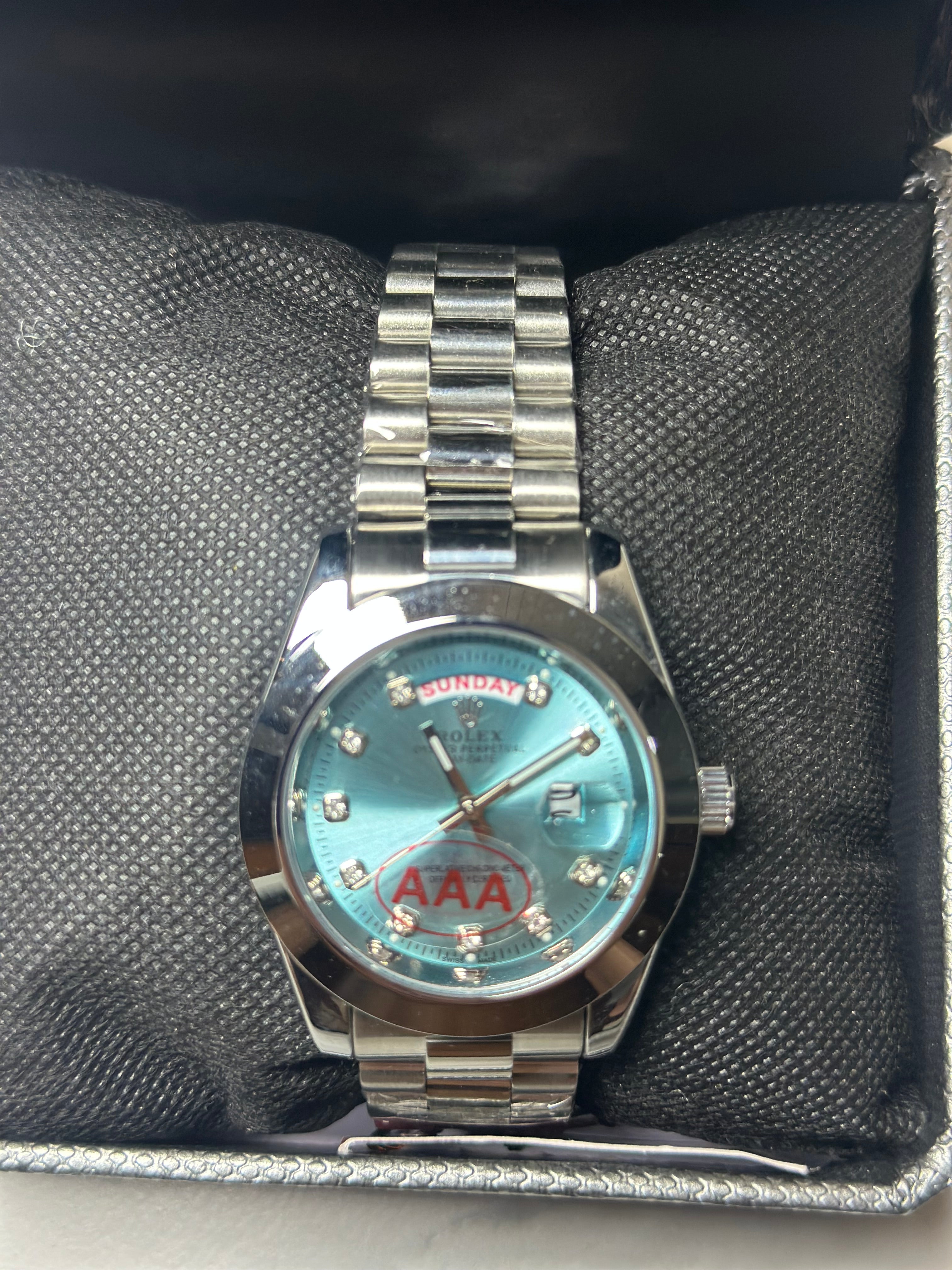 Rolex silver with light blue dial day -date
