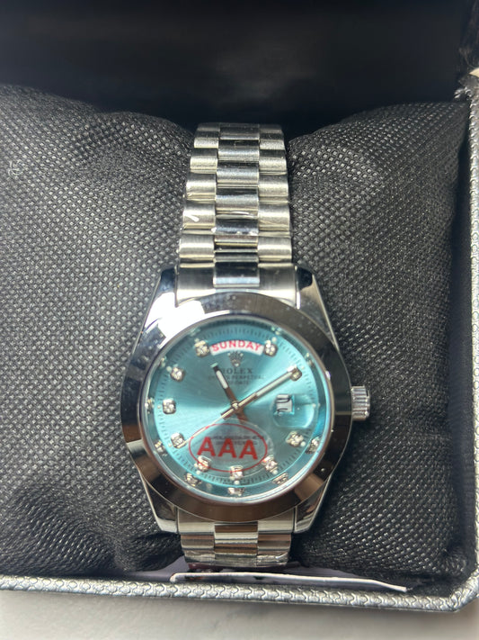 Rolex silver with light blue dial day -date